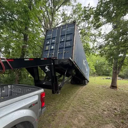 Shipping container being delivered to a property