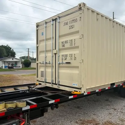Container being unloaded from delivery trailer