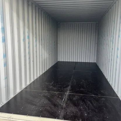Clean bright shipping container interior with dark floor